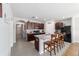 Well-lit kitchen boasts dark cabinetry, granite countertops, stainless appliances, and a spacious island with bar seating at 9785 Pepper Tree Trl, Wildwood, FL 34785