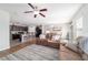 Open-concept living area with hardwood floors, comfortable seating, and kitchen view at 9785 Pepper Tree Trl, Wildwood, FL 34785