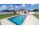 Backyard view showcasing the refreshing pool with pristine white concrete and fence at 9785 Pepper Tree Trl, Wildwood, FL 34785