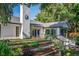 Backyard exterior with a well-maintained lawn, landscaping, patio, and a classic white stucco chimney at 4219 Magnolia Ave, Leesburg, FL 34748