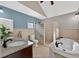 Spacious bathroom with double vanity, soaking tub, and glass block shower, providing both luxury and functionality at 4219 Magnolia Ave, Leesburg, FL 34748