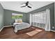 Comfortable bedroom with hardwood floors, ceiling fan, and a bright window at 4219 Magnolia Ave, Leesburg, FL 34748