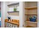 Stylish beverage station featuring dark wood countertops, and modern shelves on white walls, with view to pantry at 4219 Magnolia Ave, Leesburg, FL 34748