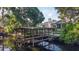 Waterfront property with a covered dock, seating area, and picturesque water views at 4219 Magnolia Ave, Leesburg, FL 34748