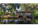 Dock view on a waterfront home, with lush greenery, wood dock and room for boats at 4219 Magnolia Ave, Leesburg, FL 34748