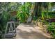 Wooden dock with a chair, boat lift and verdant surroundings, creating a peaceful waterfront setting at 4219 Magnolia Ave, Leesburg, FL 34748