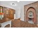 Inviting foyer showcasing unique brick fountain, tiled floors, and custom double door entry at 4219 Magnolia Ave, Leesburg, FL 34748