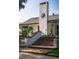 Charming front entrance featuring brick steps, decorative planters, and a prominent stucco chimney at 4219 Magnolia Ave, Leesburg, FL 34748