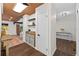 Inviting hallway featuring dark wood floors, a beverage station, and views of the living room and hallway at 4219 Magnolia Ave, Leesburg, FL 34748