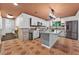 Spacious kitchen features an island, stainless steel appliances, and unique tiled floors and countertops at 4219 Magnolia Ave, Leesburg, FL 34748