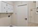 Functional laundry room featuring cabinets, granite countertops, white walls, and modern fixtures at 4219 Magnolia Ave, Leesburg, FL 34748