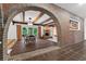 Charming dining and living area with brick archway, fireplace, beamed ceiling and sliding doors to the outside at 4219 Magnolia Ave, Leesburg, FL 34748