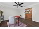 Comfortable office featuring dark wood floors, a modern ceiling fan, neutral walls and a view to brick entryway at 4219 Magnolia Ave, Leesburg, FL 34748