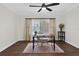 Cozy office space with dark wood floors, modern ceiling fan, neutral walls, and a window offering natural light at 4219 Magnolia Ave, Leesburg, FL 34748