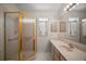 Bathroom featuring glass-enclosed shower, large mirror, and vanity area at 1007 Diego Ct, The Villages, FL 32159