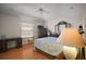 Bright bedroom featuring wood floors, a ceiling fan, and a desk for work or study at 1007 Diego Ct, The Villages, FL 32159