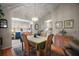 Well-lit dining room featuring wood floors, chandelier, and doorway leading to other rooms in the house at 1007 Diego Ct, The Villages, FL 32159