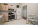 Bright kitchen with white appliances, wood cabinets, and adjacent breakfast nook at 1007 Diego Ct, The Villages, FL 32159