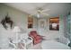 Charming lanai offering a relaxing space with comfortable seating and a ceiling fan at 1007 Diego Ct, The Villages, FL 32159