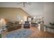 Open-concept living space with vaulted ceilings and hardwood floors, seamlessly connecting the living and dining areas at 1007 Diego Ct, The Villages, FL 32159