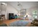 Inviting living room with vaulted ceilings, hardwood floors, and cozy seating arrangements at 1007 Diego Ct, The Villages, FL 32159