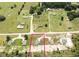 Aerial view of a home showcasing the entire lot with a defined boundary line with proximity to nearby houses at 10128 County Road 229, Oxford, FL 34484