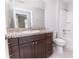This bathroom has a dark wood vanity, toilet, shower and bath at 10128 County Road 229, Oxford, FL 34484