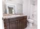 This bathroom has a dark wood vanity, toilet, shower and bath at 10128 County Road 229, Oxford, FL 34484