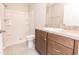 This bathroom features a wood vanity, toilet, and shower at 10128 County Road 229, Oxford, FL 34484
