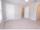 A neutral bedroom features light gray tile flooring and white doors at 10128 County Road 229, Oxford, FL 34484