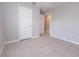 A neutral bedroom features white doors and light gray tile flooring at 10128 County Road 229, Oxford, FL 34484