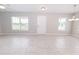 Open living area with tiled floors, neutral walls, and large windows, offering plenty of natural light at 10128 County Road 229, Oxford, FL 34484