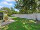 Spacious backyard featuring a well-manicured lawn and a privacy wall, perfect for outdoor enjoyment at 10161 Sw 87Th Ter, Ocala, FL 34481
