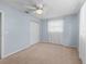 Bedroom featuring neutral walls, carpet, a ceiling fan and window with white curtains at 10161 Sw 87Th Ter, Ocala, FL 34481