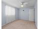 Neutral bedroom with a ceiling fan, light blue walls, light colored carpet, and a window at 10161 Sw 87Th Ter, Ocala, FL 34481