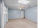 Spacious carpeted bedroom with a ceiling fan and natural light from a window and skylight at 10161 Sw 87Th Ter, Ocala, FL 34481