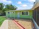 Charming single-story home with light green siding, white trim, and a well-maintained front yard at 10161 Sw 87Th Ter, Ocala, FL 34481