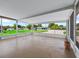 A screened-in lanai provides an airy and bright space with clear views of the surrounding landscape at 10161 Sw 87Th Ter, Ocala, FL 34481