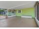 View of the attached and enclosed Florida room featuring a wall of light green, horizontal siding at 10161 Sw 87Th Ter, Ocala, FL 34481
