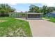 Well-kept home featuring a large screened-in porch and a neatly landscaped front yard at 10161 Sw 87Th Ter, Ocala, FL 34481