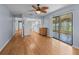Spacious open layout with hardwood floors and ceiling fan connecting the living room, dining, and kitchen areas at 10161 Sw 87Th Ter, Ocala, FL 34481