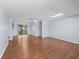 Open-concept living room with hardwood floors, neutral walls, and access to a porch area at 10161 Sw 87Th Ter, Ocala, FL 34481