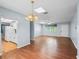 Open-concept living and dining area with hardwood floors and a view into the well-equipped kitchen at 10161 Sw 87Th Ter, Ocala, FL 34481