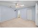 Spacious main bedroom with a ceiling fan, neutral carpet, and an en-suite bathroom entrance at 10161 Sw 87Th Ter, Ocala, FL 34481