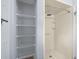 Shower with silver shower head and hardware with storage shelving at 10161 Sw 87Th Ter, Ocala, FL 34481
