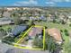 Aerial view of a home with a brown roof and solar panels surrounded by lush landscaping at 109 Falling Acorn Ave, Groveland, FL 34736