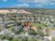Aerial view of a home with a brown roof and solar panels surrounded by lush landscaping at 109 Falling Acorn Ave, Groveland, FL 34736