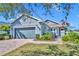 Charming single-story home with a well-manicured lawn, brick walkway, and attached two-car garage at 109 Falling Acorn Ave, Groveland, FL 34736