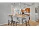 Kitchen with granite counters, stainless appliances, an island with barstool seating, and pendant lighting at 109 Falling Acorn Ave, Groveland, FL 34736