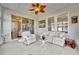Covered lanai with tile flooring, ceiling fan, and sliding glass doors at 109 Falling Acorn Ave, Groveland, FL 34736